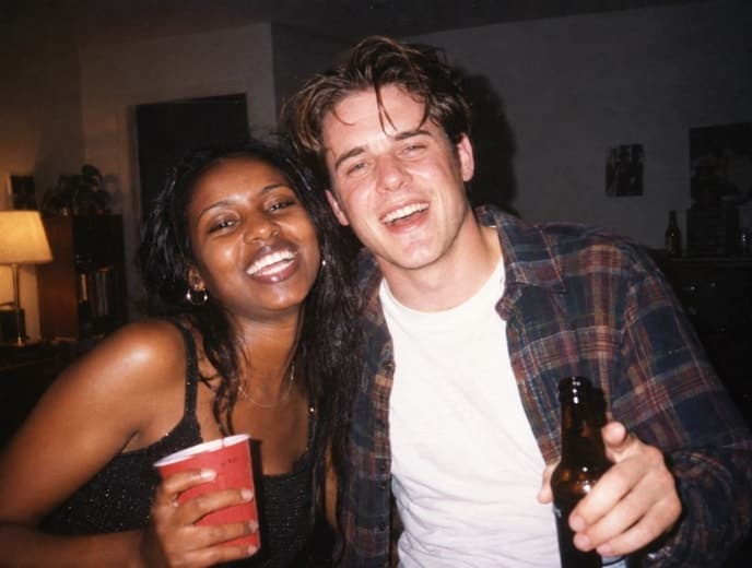 Two friends caught in the direct flash of a party snapshot